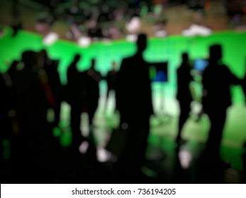 Out Of Focused And Silhouetted People In Green Screen Studio, Behind The.scene Of Pre Production Of News Broadcasting.