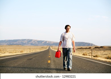 Out Of Gas - Teenager Male Walking Down Rural Highway With Empty Red Gas Can