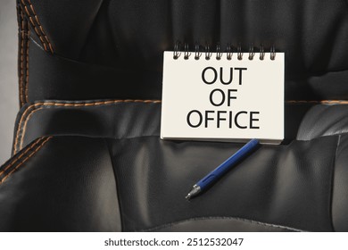 Out Of Office message on notepad with a office chair.