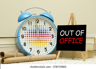 Out Of Office Message Written On A Small Blackboard. It Is Almost 12 O'clock.