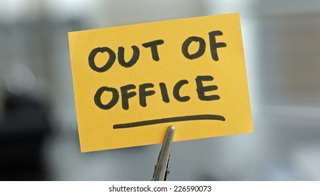 Out of office written on a card at the desk