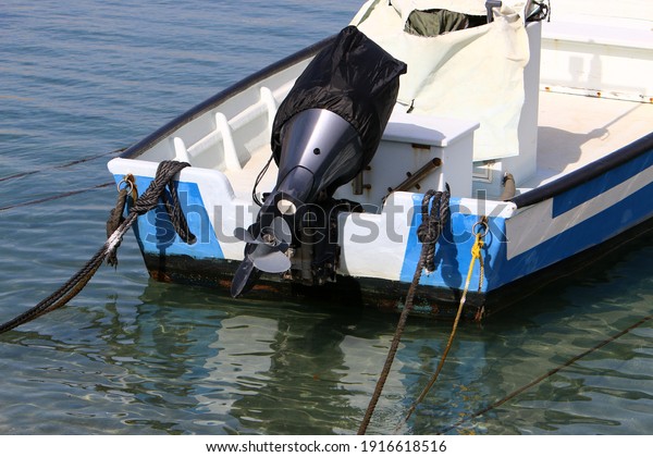 Outboard\
motor propeller. Boat in the port of Tel\
Aviv.
