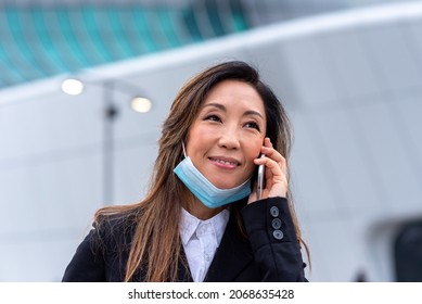 Outbreak Covid19 Time, Portrait Of Japanese Business Woman Calling With Facemask, Confident And Smiling Entrepreneur Working In Remote With Smartphone, Copy Space