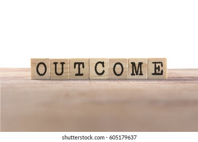 Outcome Word Written In Wooden Cube