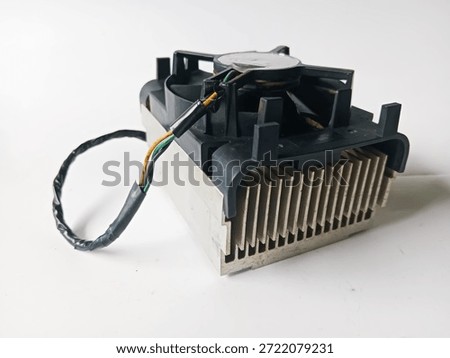 An outdated CPU cooler. Representing e-waste and old desktop computer hardware. Typical OEM style; Original Equipment Manufacturer, boxy shape with black plastic hooks.