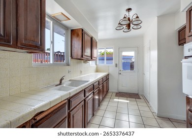 Outdated Kitchen with old cabinets and counters