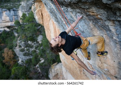 Outdoor Activity. Extreme Rock Climbing Lifestyle. Male Rock Climber Od A Cliff Wall. 