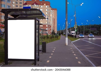 Outdoor Advertising Bus Shelter In The Evening. Blank Bus Stop Billboard In The City At Night. City.