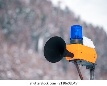 Outdoor Alert Siren With A Speaker And A Blue Warning Light In A Swiss Village Of Cinuos-Chel, Engadine