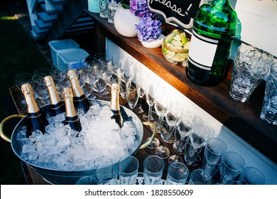 Outdoor Bar Cart With Champagne Bottles On Ice