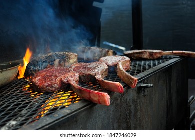 Outdoor Barbecue Grill A Classic Traditional Open Bbq Pit. Steaks And Meat Cooked On A Wood Fire Grill. 