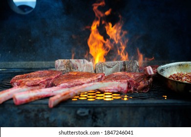 Outdoor Barbecue Grill A Classic Traditional Open Bbq Pit. Steaks And Meat Cooked On A Wood Fire Grill. 