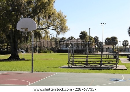 Outdoor basketball courts and baseball fields with bleachers.