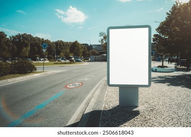 Outdoor billboard mockup on a roundabout, with a clear blue sky and surrounding greenery in a suburban area. The blank white advertising space is ready for custom content; a 30 km h speed limit sign - Powered by Shutterstock