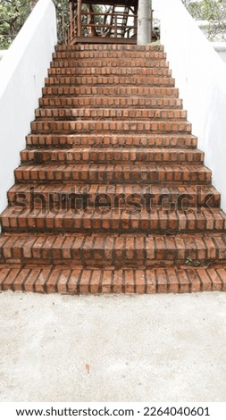 Outdoor bricks stair step and white wall.