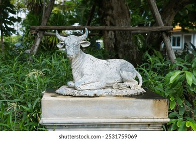 An outdoor bull sculpture set in a lush garden where art meets nature, creating a serene and captivating environment. - Powered by Shutterstock