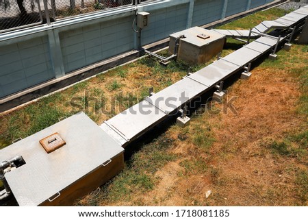 Outdoor cable tray with cover and manhole with submersible pump