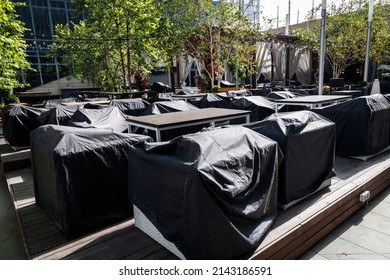 Outdoor Cafe With Furniture Covered With Rain Covers. Preparing A Street Cafe For The Season. Almaty, Kazakhstan - September 20, 2021