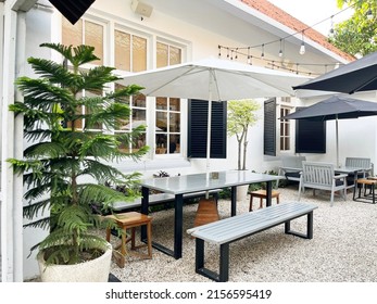 The Outdoor Cafe And Restaurant Section Is Equipped With Seating And A Large Garden Umbrella Table. Placed On A Stretch Of White Coral