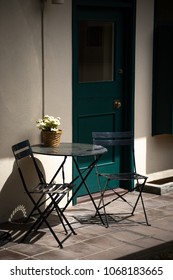 Outdoor Cafe Sitting Area With Table And Chair Patio Furniture, With Space For Text On Top