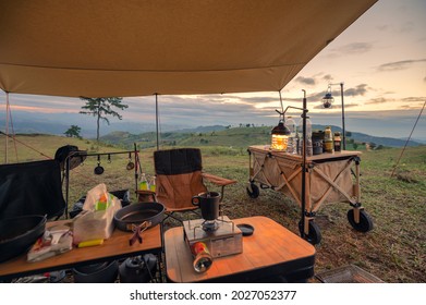 Outdoor Camping Equipment In A Tent Setting On Hill In The Evening At Countryside