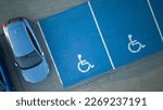 Outdoor car parking with handicapped symbol icon. Parking places reserved for disabled person. Aerial drone view.