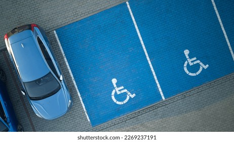 Outdoor car parking with handicapped symbol icon. Parking places reserved for disabled person. Aerial drone view. - Shutterstock ID 2269237191
