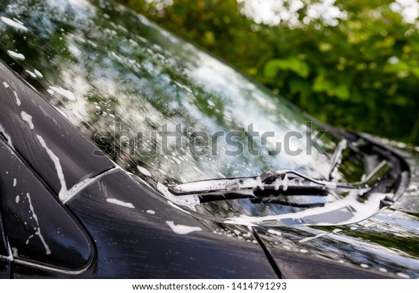 Outdoor car wash. Gentle Car\
Washing. Modern Car Covered by soap and Water. automobile, auto\
wash foam water,Auto detailing or valeting concept. Selective\
focus.
