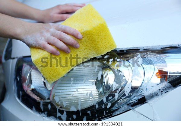 Outdoor car wash with yellow\
sponge