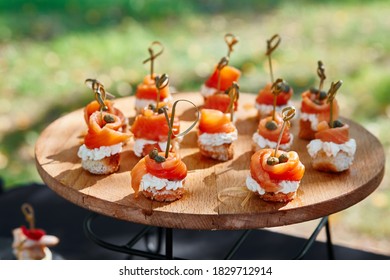 Outdoor Catering Banquet In Summer. Table With Snacks And Canapes  At A Summer Banquet