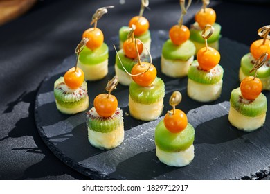 Outdoor Catering Banquet In Summer. Table With Canapes And Fruits At A Summer Banquet