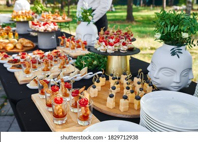 Outdoor Catering Banquet In Summer. Table With Snacks, Canapes And Fruits At A Summer Banquet