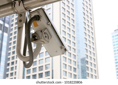 Outdoor CCTV security camera system operating in modern city building background.  surveillance security, Online video network connection, video real time and safety technology concept.