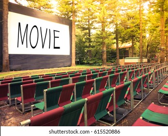 Outdoor Cinema Screen And Movie Chair In Garden.