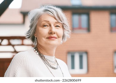 Outdoor close up portrait of beautiful 55 - 60 year old woman - Shutterstock ID 2262800699