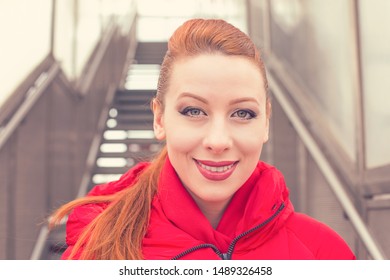 Outdoor Closeup Portrait Of A Beautiful Woman Wearing Red Coat