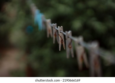 Outdoor Clothes Dryer. Free Space For Ideas. Blue And Wooden Clothespins On A Clothesline. Selective Focus On One Clothespin.