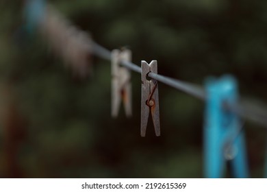 Outdoor Clothes Dryer. Free Space For Ideas. Blue And Wooden Clothespins On A Clothesline. Selective Focus On One Clothespin.