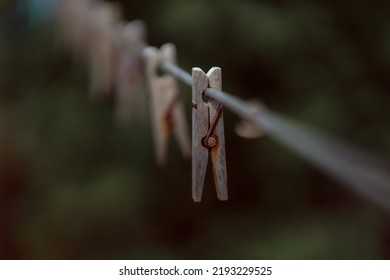 Outdoor Clothes Dryer. Free Space For Ideas. Blue And Wooden Clothespins On A Clothesline. Selective Focus On One Clothespin.