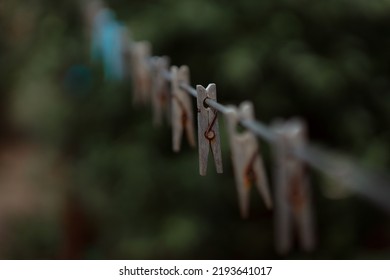 Outdoor Clothes Dryer. Free Space For Ideas. Blue And Wooden Clothespins On A Clothesline. Selective Focus On One Clothespin.