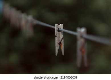 Outdoor Clothes Dryer. Free Space For Ideas. Blue And Wooden Clothespins On A Clothesline. Selective Focus On One Clothespin.