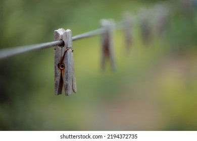 Outdoor Clothes Dryer. Free Space For Ideas. Blue And Wooden Clothespins On A Clothesline. Selective Focus On One Clothespin.