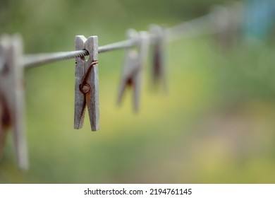 Outdoor Clothes Dryer. Free Space For Ideas. Blue And Wooden Clothespins On A Clothesline. Selective Focus On One Clothespin.