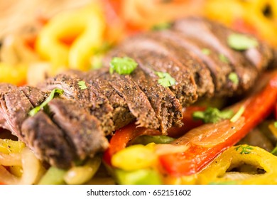 Outdoor Cooking. Steak Fajitas With Bell Peppers And Yellow Onion On A Cast Iron Fajita Skillet.