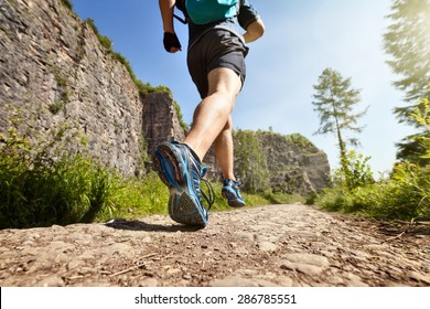 Outdoor cross-country running in summer sunshine concept for exercising, fitness and healthy lifestyle