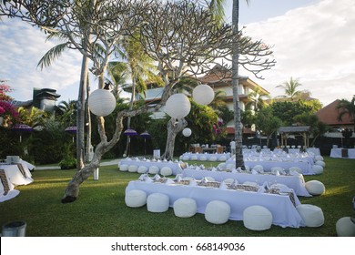 outdoor decoration, party chair table arrangement on the beach with white theme, set up for dinner party on the beach, ready for wedding ceremony