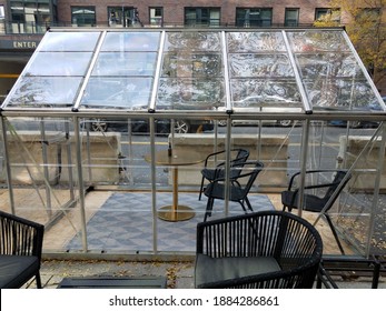 Outdoor Dining Area With Tables And Glass Enclosure