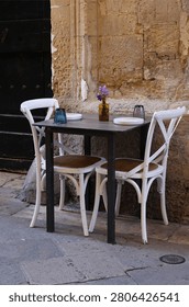 Outdoor dining table set for two in Lecce, Southern Italy