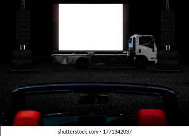 Outdoor Drive In Theater And Audience In Convertible Luxury Saloon Car And With Mobile Cinema In Night As Activity During Social Distancing Adapt To New Normal Of The Coronavirus COVID-19 Pandemic.