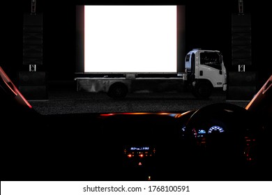 Outdoor drive in theater or drive in cinema, with mobile truck cinema in light night as activity during social distancing adapt to new normal of the coronavirus COVID-19 pandemic.